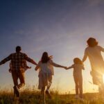famille qui court vers le soleil couchant